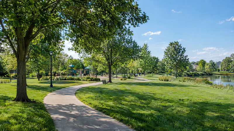Family-friendly neighborhood park with a curving path and shade trees